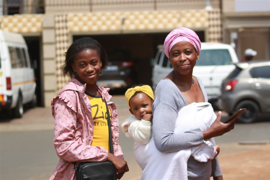 Two women and children outside a South African home